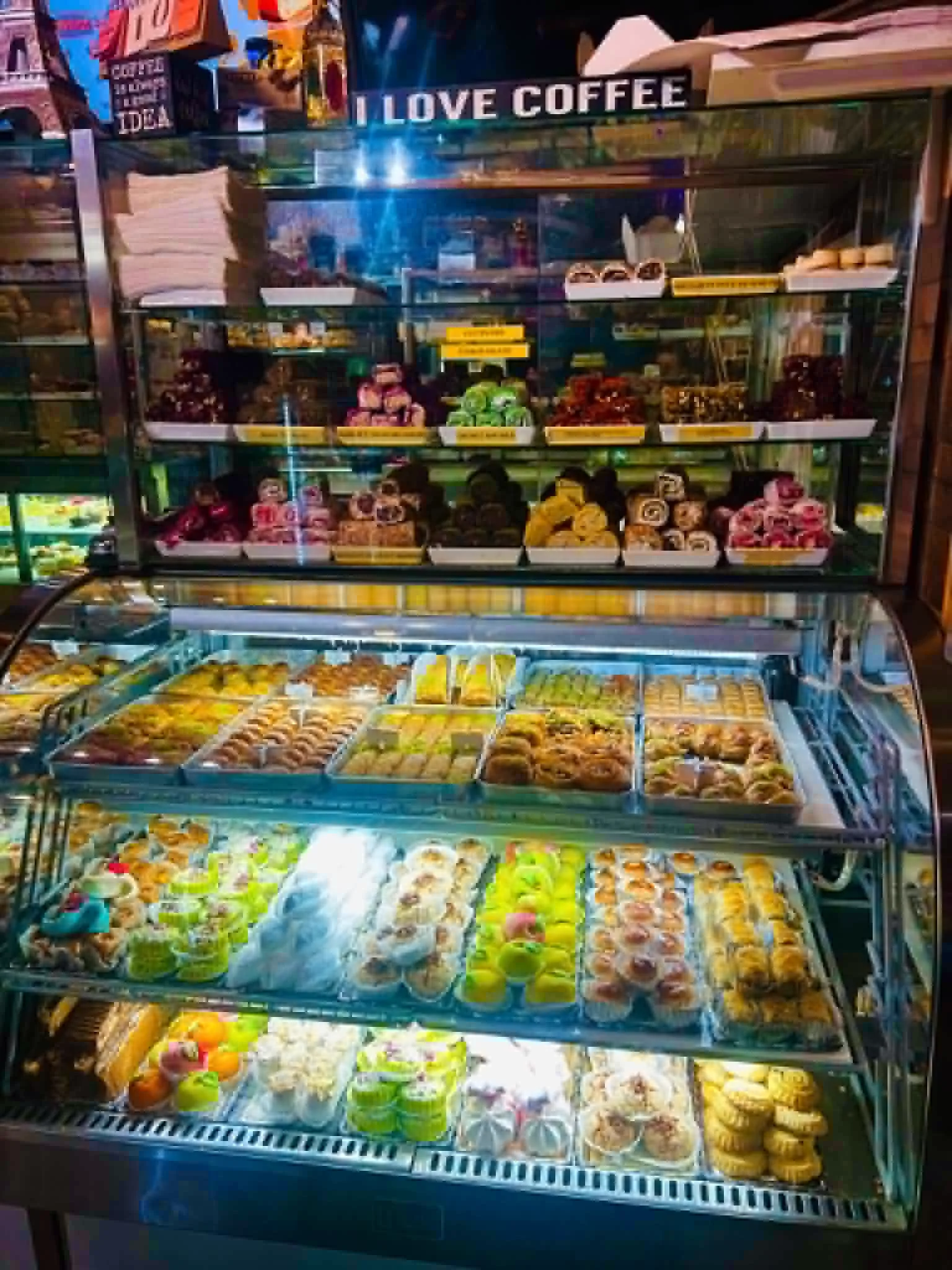 Belmo Café's pastry display case, filled with tarts, cheesecakes, and macarons